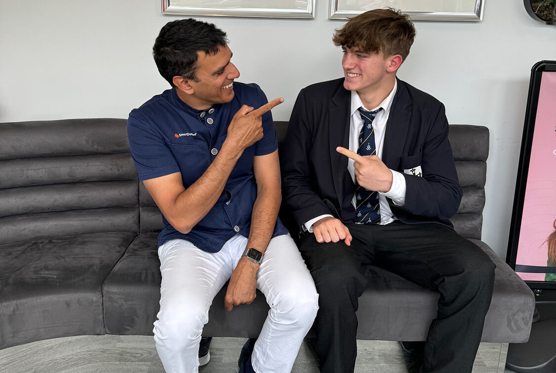 Dr Patel posing for a picture with a client